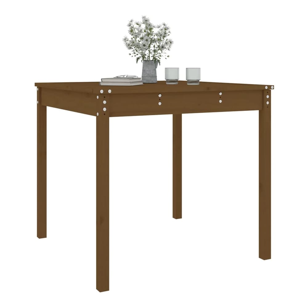 A honey brown solid wood pine garden table with a book and glasses
