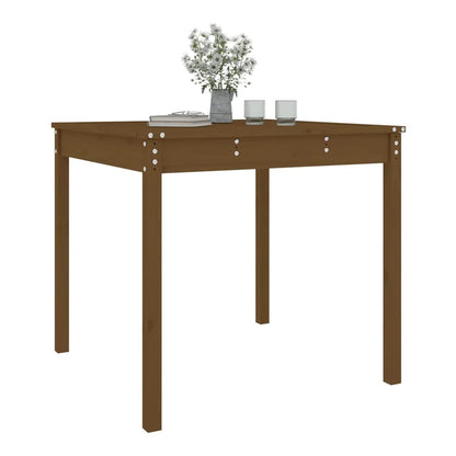 A honey brown solid wood pine garden table with a book and glasses