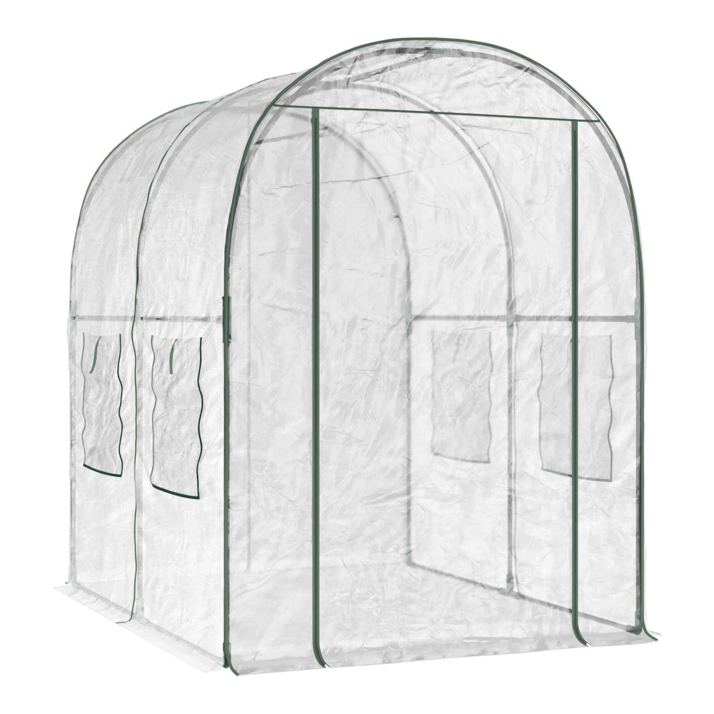 The transparent PVC greenhouse with a green frame, showing the arched roof and sides