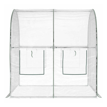 Inside the transparent PVC greenhouse, showing the frame structure and roll-up windows