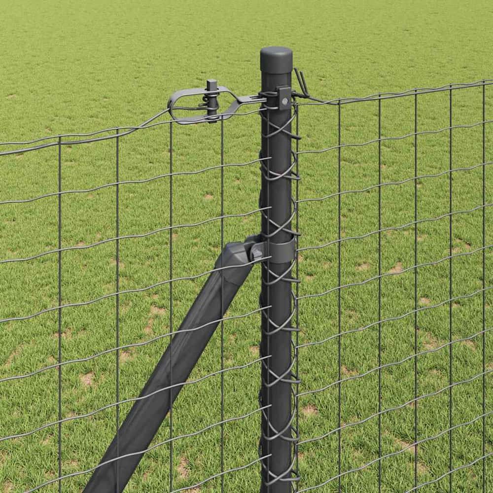Close up of a ground spike fence post connected to wire fencing