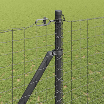 Close up of a ground spike fence post connected to wire fencing