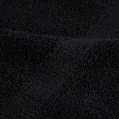 Close up of the ribbed edge of a black guest towel