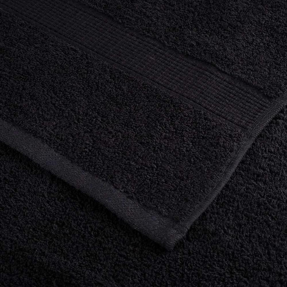 Corner detail of a black guest towel showing the weave