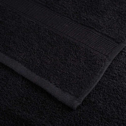 Corner detail of a black guest towel showing the weave