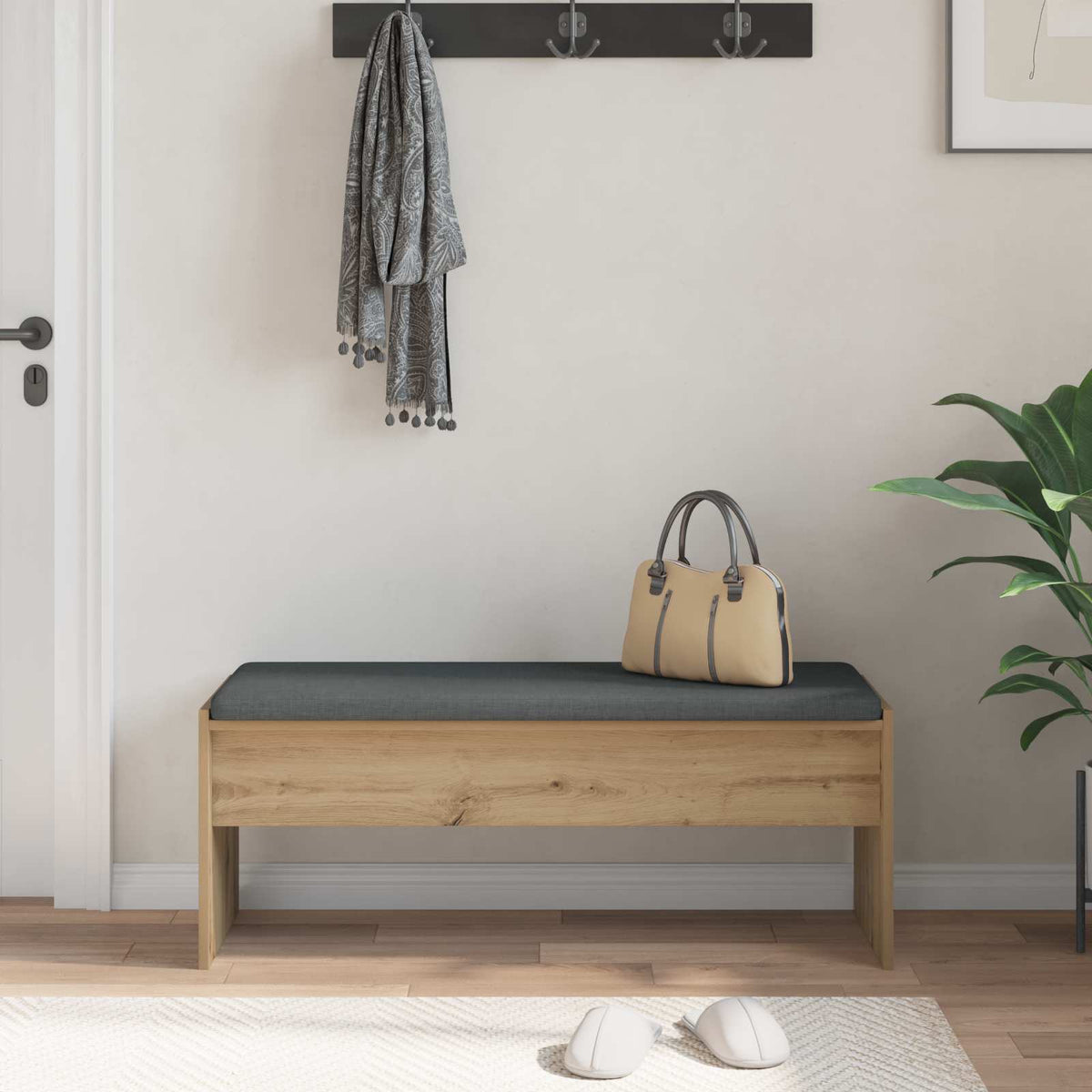 The storage and entryway bench in a hallway with a bag, plant and slippers