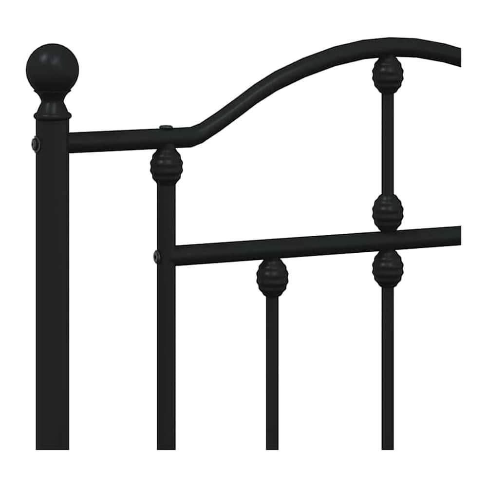 close-up of the decorative finial and spindles on the black metal headboard