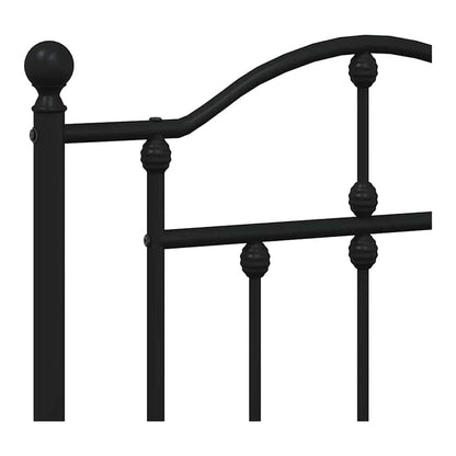 close-up of the decorative finial and spindles on the black metal headboard