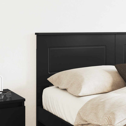 Close up of the black engineered wood headboard on a bed