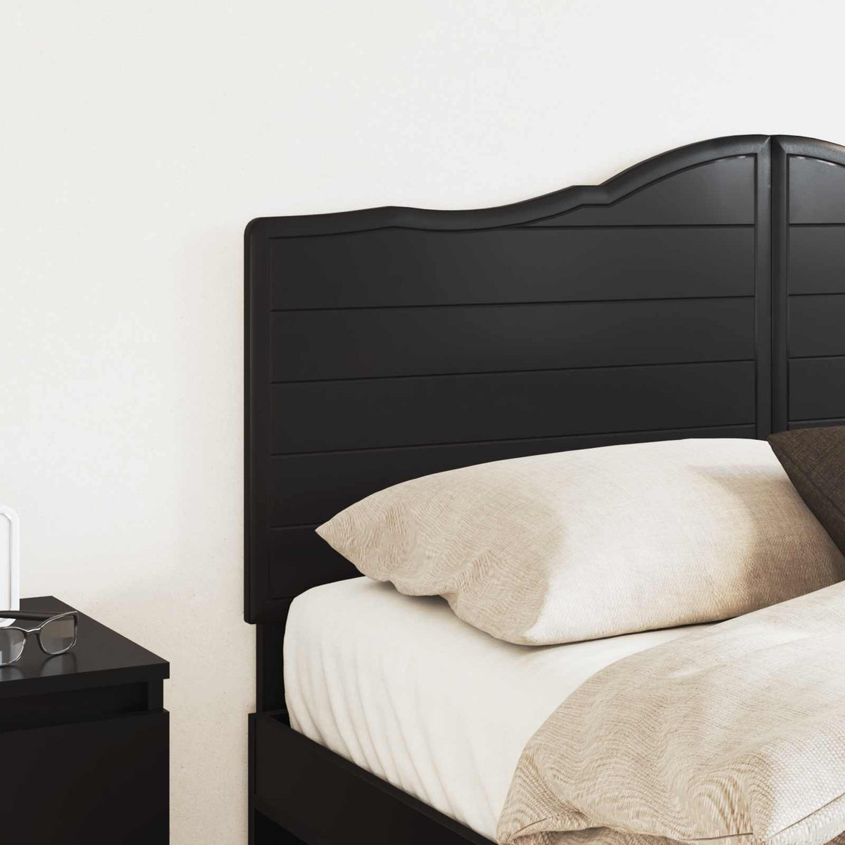 Close up of the black oak engineered wood headboard on a bed