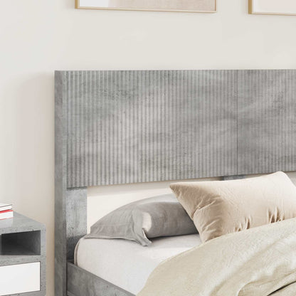 The headboard positioned behind a bed with pillows and bedding in a bright room