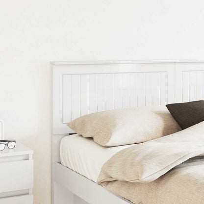 A close-up of the headboard positioned behind a bed with pillows