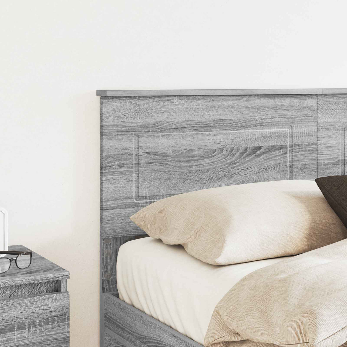 Close up of the grey Sonoma engineered wood headboard on a bed