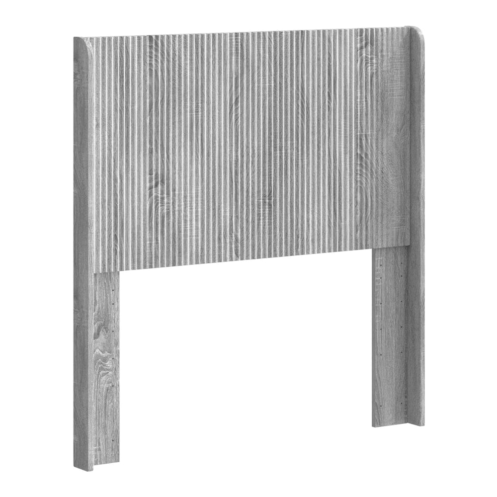 the headboard with a textured grey wood grain finish standing on two vertical supports