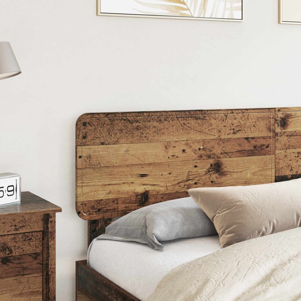 The old wood effect headboard fitted to a bed with pillows and a bedside table
