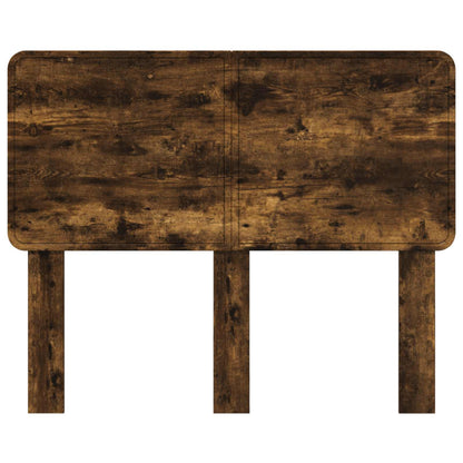 The headboard with a smooth dark wood finish and rounded corners on a white background