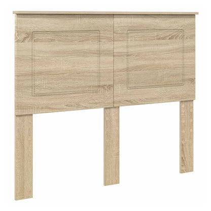 The headboard has a light wood effect finish with two recessed panel details on the front