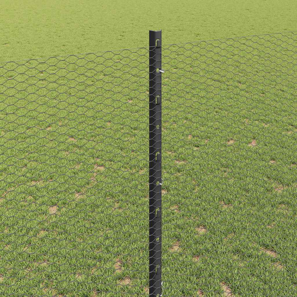 close up of the hexagonal fence mesh attached to a fence post in a grassy area