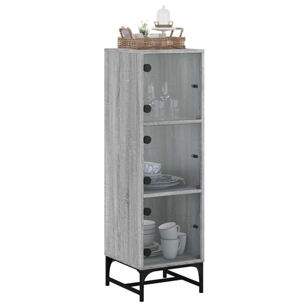 tall grey cabinet with three glass doors and black legs filled with plates and cups