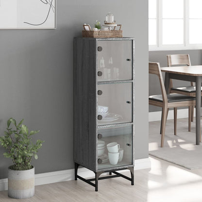 tall grey cabinet with three glass doors and black legs displayed in a dining room setting