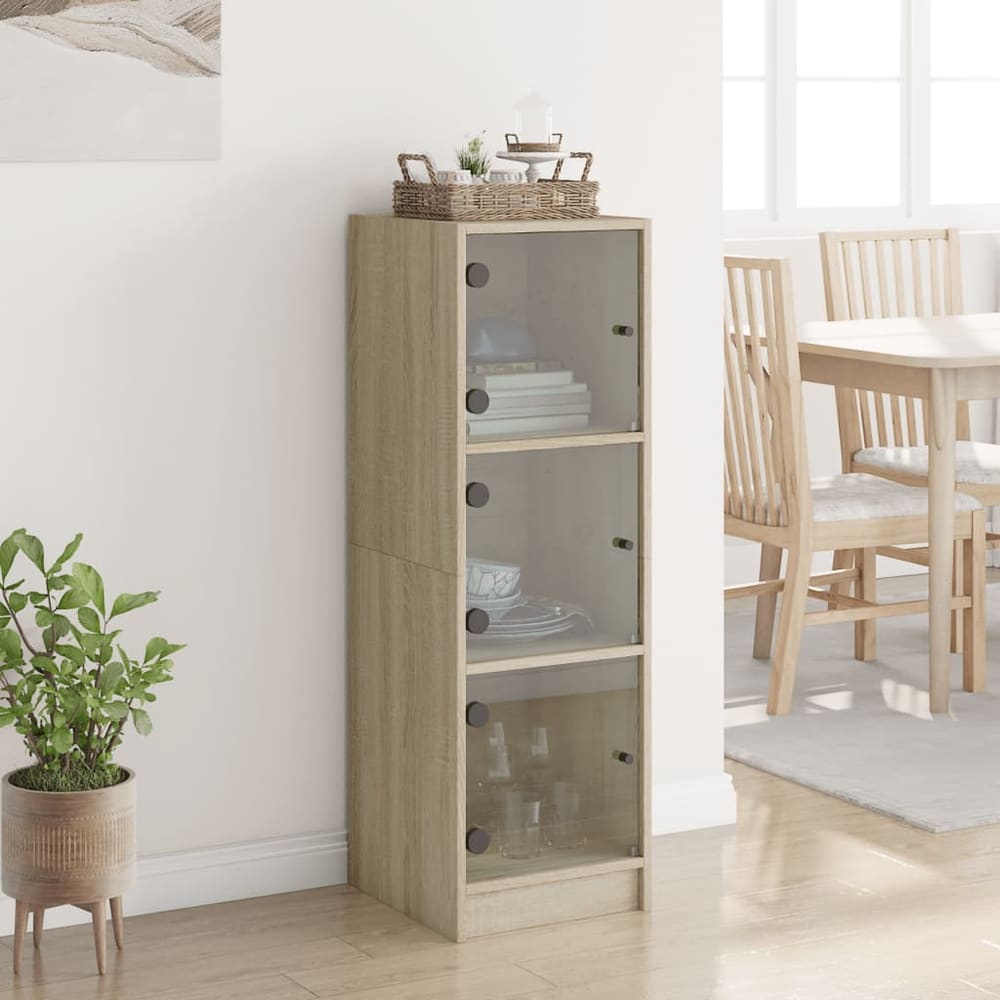The tall narrow cabinet with three glass doors and shelves inside, shown in a room setting