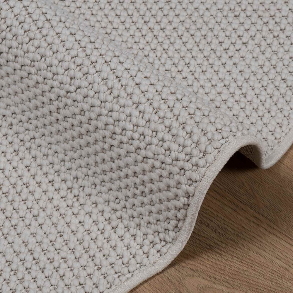 Close-up of the textured weave of the LUGO cream rug