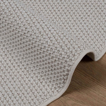 Close-up of the textured weave of the LUGO cream rug