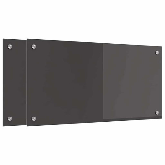 Two dark grey tempered glass kitchen backsplashes with screw holes