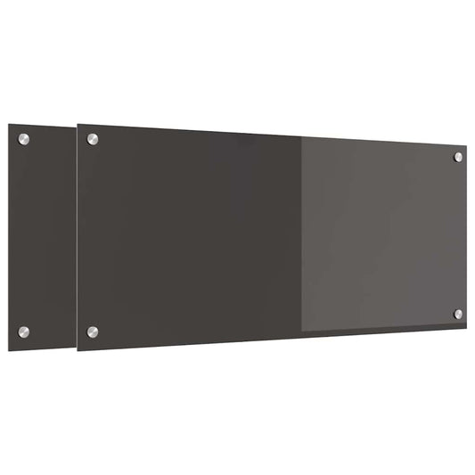 Two dark grey glass kitchen backsplashes mounted on a white wall