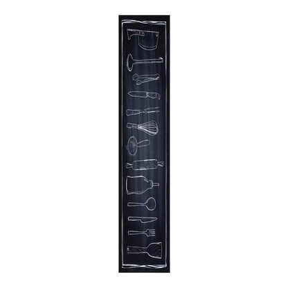 Close-up of the black kitchen rug showing a vertical line of chalk-style drawings of kitchen utensils