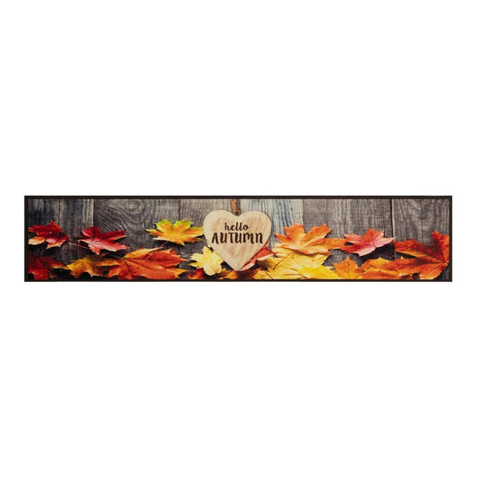 The kitchen rug shows a pattern of autumn leaves against a wooden background with a heart decoration