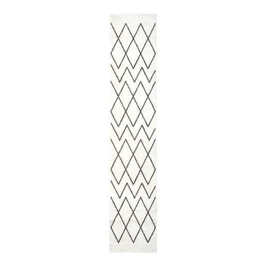 The white kitchen rug with a black geometric pattern