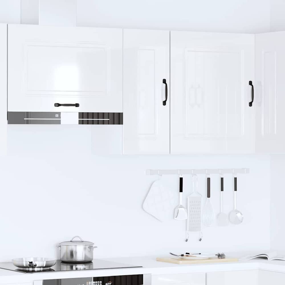Several white kitchen cabinets mounted above a stove and counter