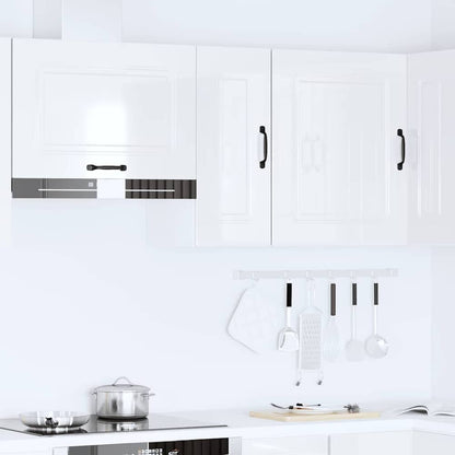 Several white kitchen cabinets mounted above a stove and counter
