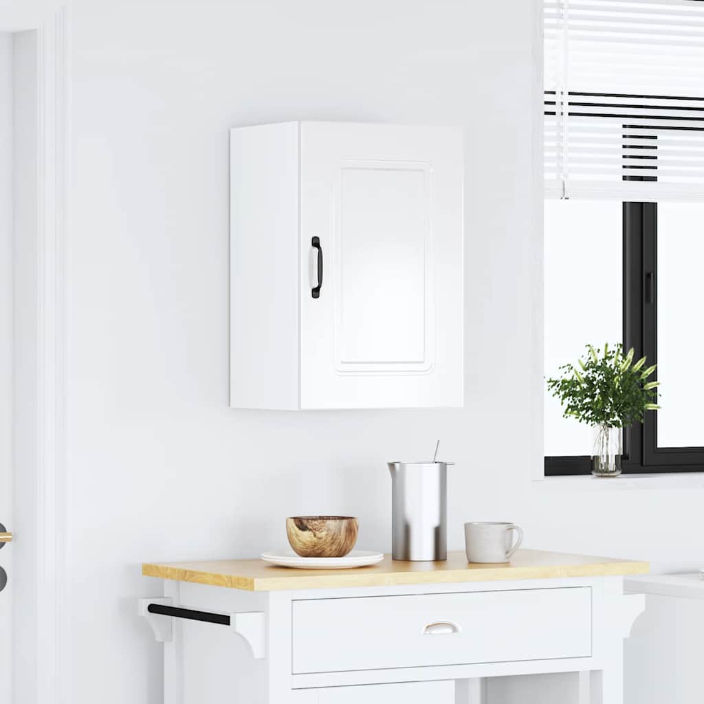 The kitchen cabinet mounted on a white wall above a wooden kitchen island