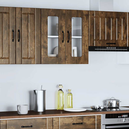 A kitchen wall cabinet with glass doors fitted above a worktop with kitchen appliances