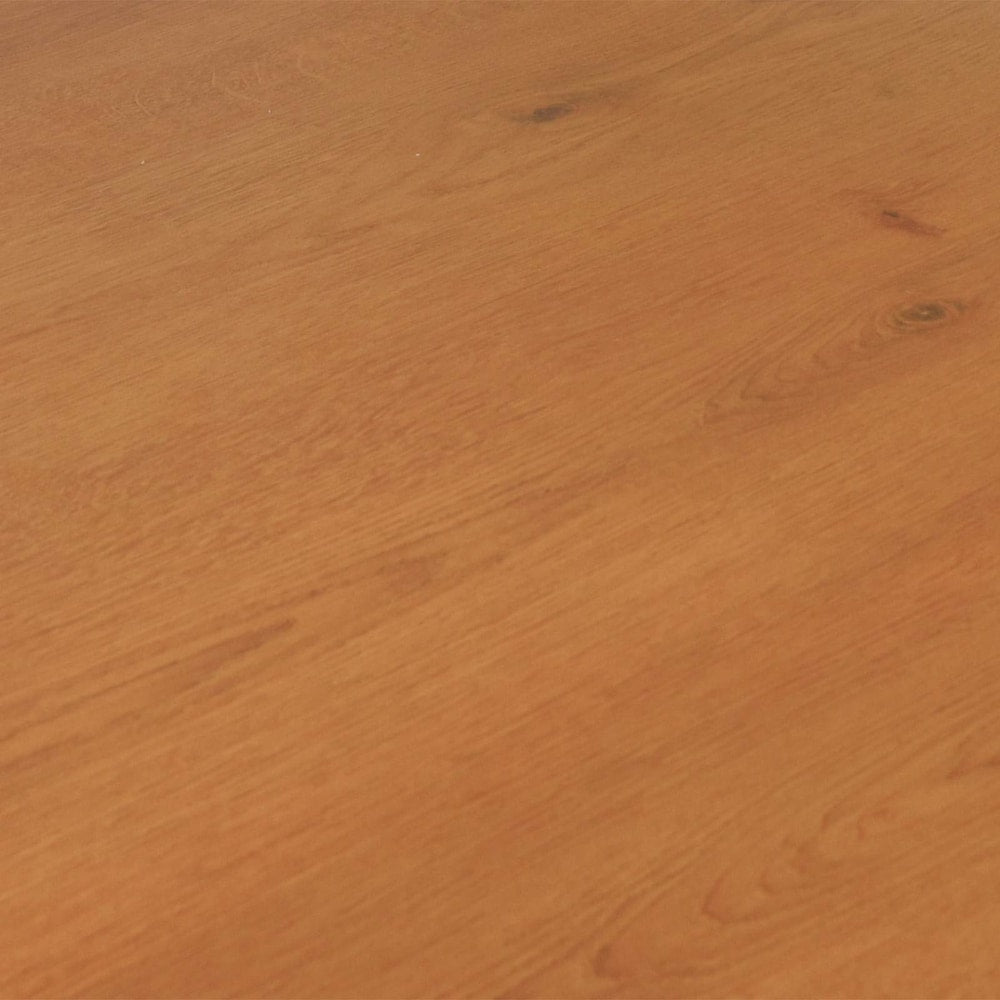 A section of the sandy beige laminate flooring showing the natural wood effect