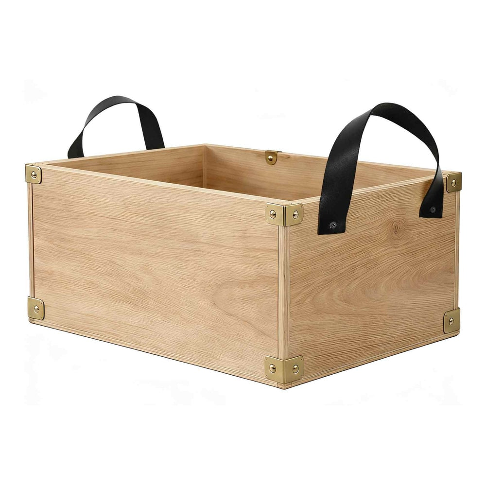 A wooden storage box with black leather handles and brass corner protectors