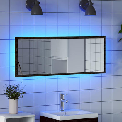 The bathroom mirror illuminated with blue light while hanging above a vanity unit