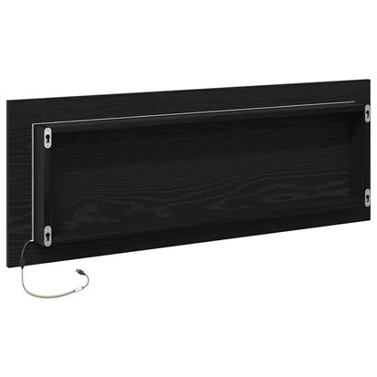 The bathroom mirror showing the back panel with mounting brackets and a power cable