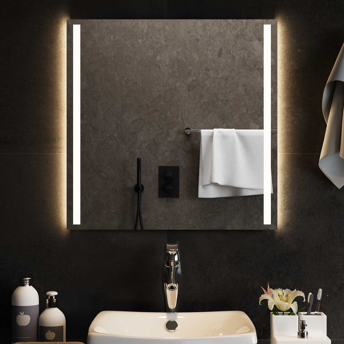 A bathroom mirror with illuminated LED strips, reflecting a modern bathroom sink and tap