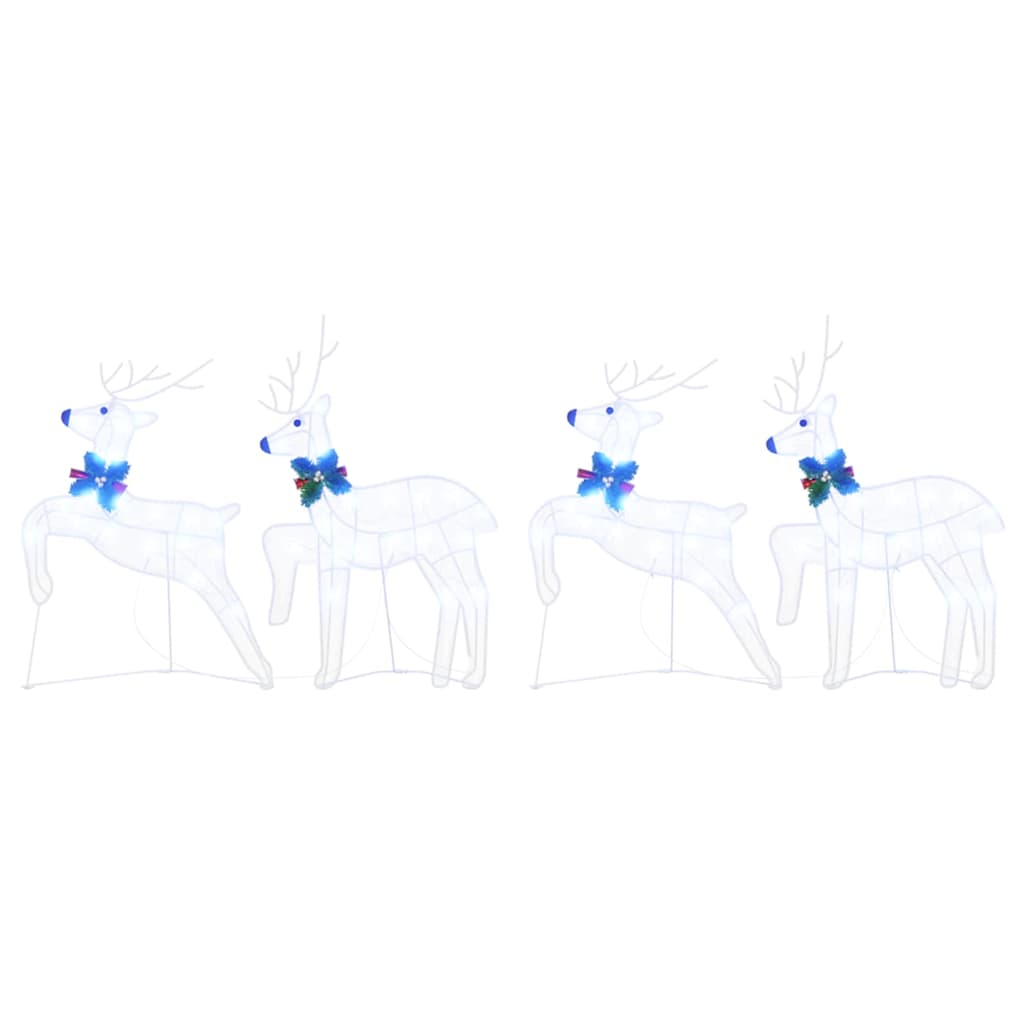 Four white fabric reindeer figures with blue bows arranged in two pairs
