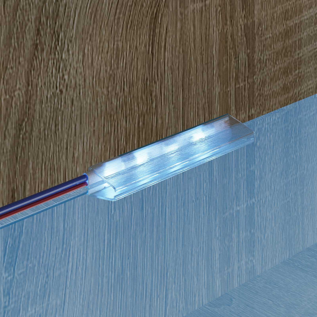 The LED strip light installed under a shelf