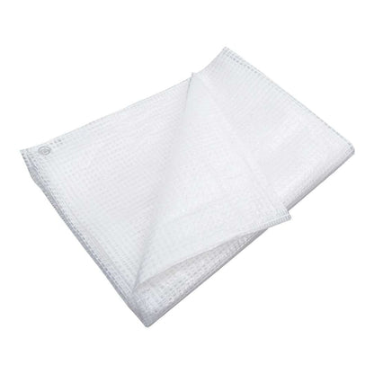 A white woven plastic tarpaulin folded neatly, showing its texture and edges