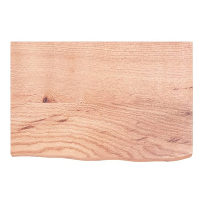 The wooden worktop viewed from directly above showing the wood grain and wavy front edge