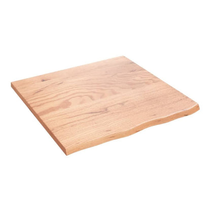 the bathroom worktop seen from a high angle showing the light brown wood grain and wavy edge