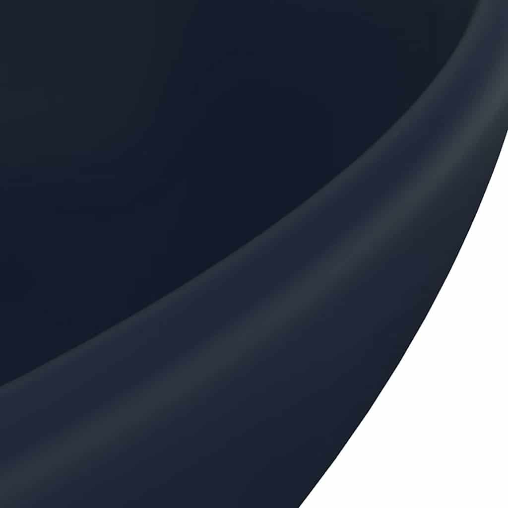 A close-up of the bathroom basin surface highlighting the smooth matt dark blue finish