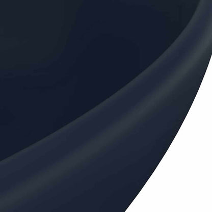 A close-up of the bathroom basin surface highlighting the smooth matt dark blue finish