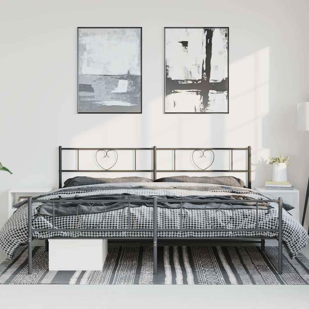 black metal bed frame without mattress in a room with bedding