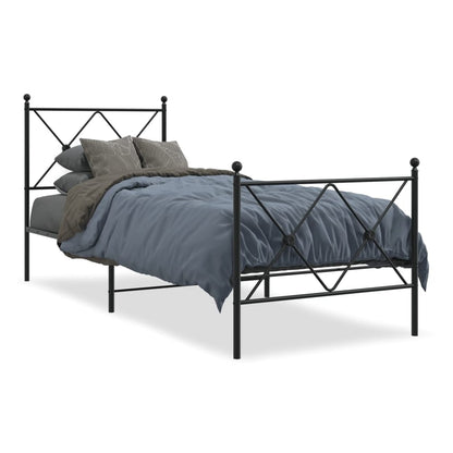 The black metal bed frame with a footboard, made up with a mattress and bedding